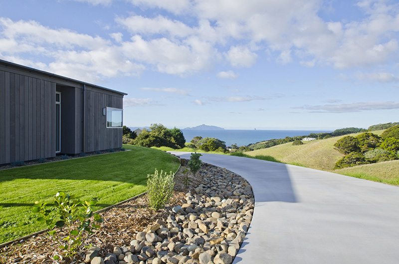 Exterior view of custom home build with sea view and grass